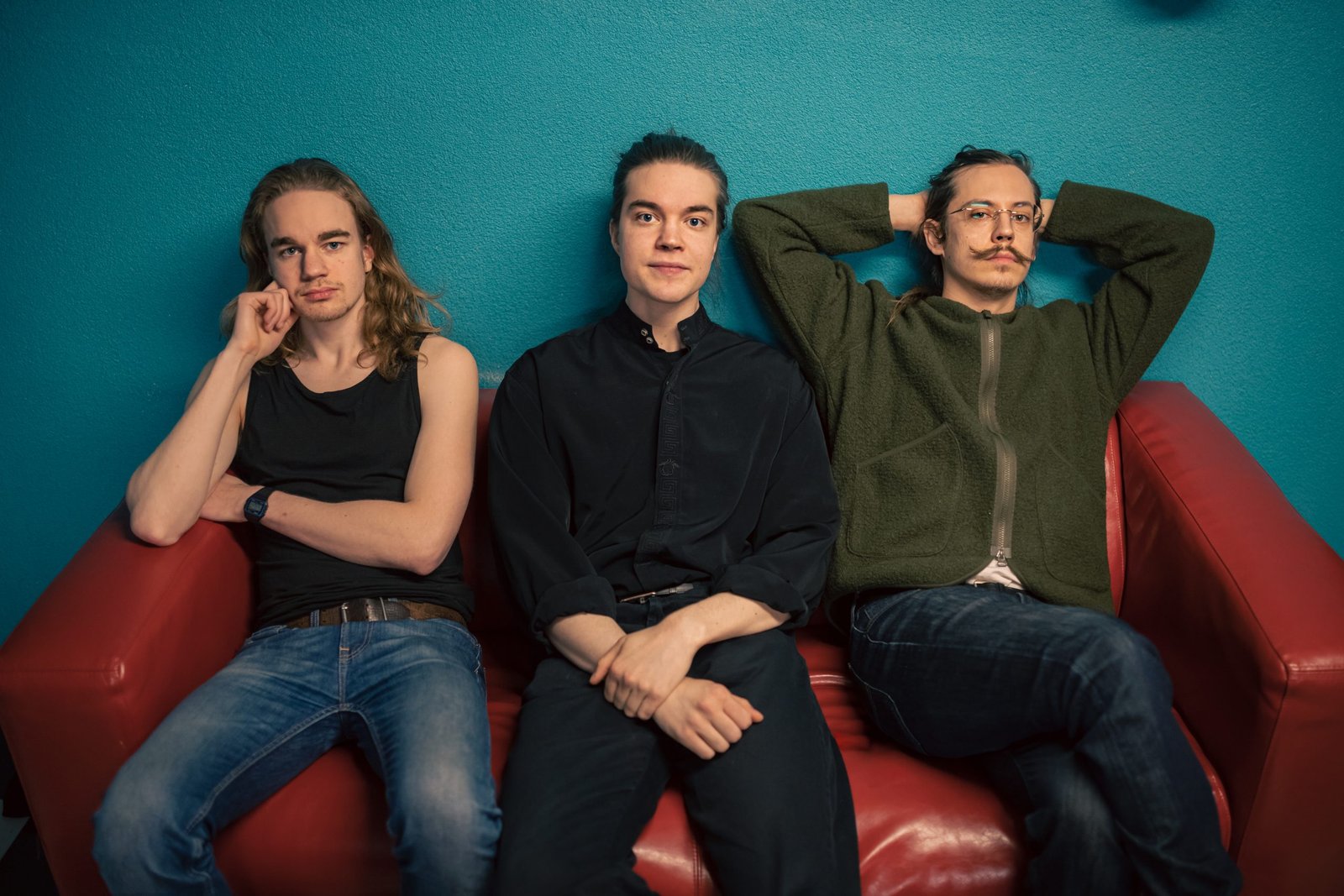 Three men sitting on a couch
